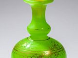 un vase vert surmonté d'une boule jaune