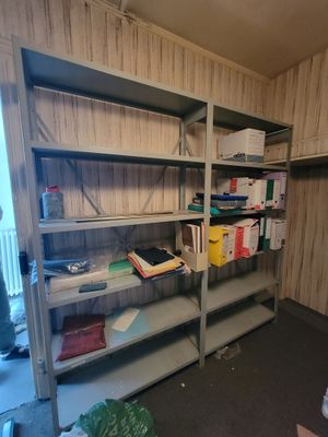 a room that has a shelf with many books on it