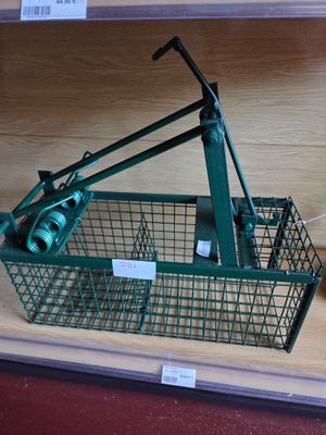 a green wire basket with a machine on top of it