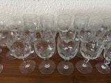 several empty wine glasses are lined up on a wooden table