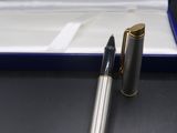 the pen is sitting in the box on the table next to the pen