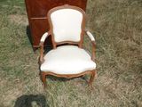 une chaise posée dans l'herbe à côté d'une commode