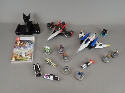 a lot of action figures and a video game on the table