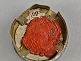 a close up of a coin with a red seal on it