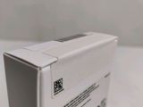 the back of a white box on a table with a white wall behind it