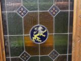 a picture of a stained glass window with a lion on it