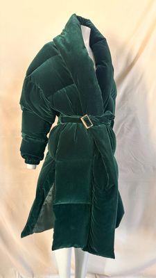 an image of a green velvet coat on a mannequin
