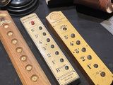 three remote controls sitting on a table next to an old camera
