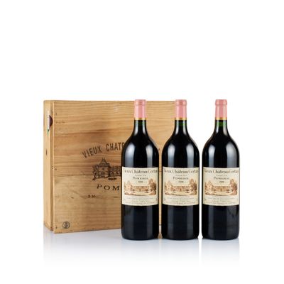 three bottles of red wine in a wooden box