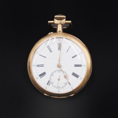 a gold pocket watch with roman numerals on it