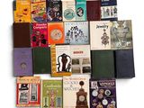 a lot of books that are stacked together on a table