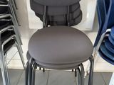 a stack of chairs and a chair with a price tag on it