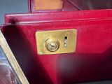 a close up of a red purse with a lock on it