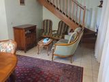 a living room with a staircase and a rug on the floor