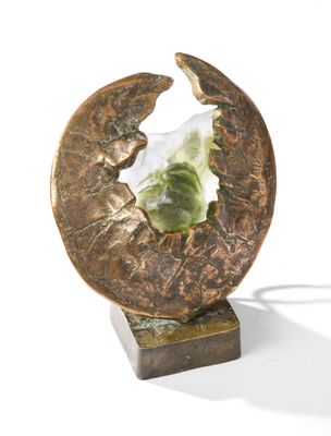 a sculpture of a leaf and a piece of paper on a stand