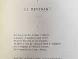 an open book with a poem written in french
