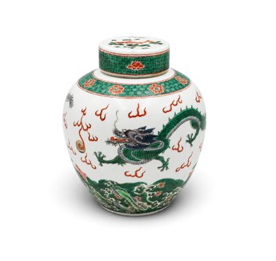 an oriental vase with a green dragon on the lid
