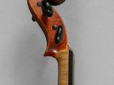 a close up of a violin on a gray background