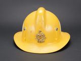 an image of a yellow fireman ' s helmet on a black background