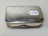 a silver box with a label on it on a table