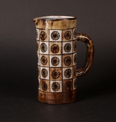 a brown and white coffee mug with a pattern on it