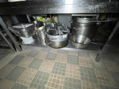 many pots and pans that are sitting on the floor