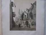 a picture of an old picture of a street in the middle of town