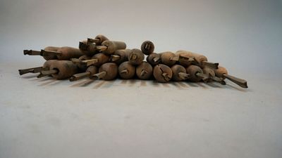 a pile of wooden pegs sitting on a white surface
