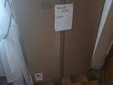 a sign on the door of a bathroom that is taped to the wall