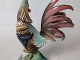 a figurine of a rooster on a pedestal