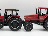 two red tractors that are sitting next to each other