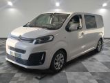 the white van is parked in a room with a checkered floor