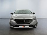 the front view of a silver car in a white room