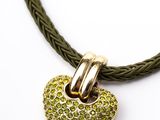 un gros plan d'un collier vert orné d'un pendentif en forme de cœur