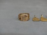 a gold ring and two other gold rings on a table