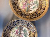 two chinese plates with gold and blue designs on them