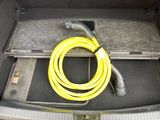 a yellow hose in the trunk of a car