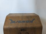 an old wooden box with a metal handle on a white surface