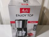 packaging of a coffee maker sitting on top of a white table