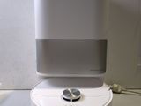 a white and gray air purifier sitting on top of a table