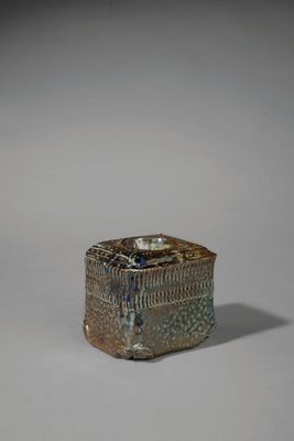 une image représentant une petite boîte posée sur une surface blanche
