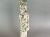 statue of a man with a head on a base on a gray background