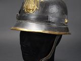 an old helmet with a gold emblem on it
