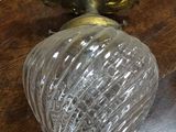 a glass vase sitting on a wooden table next to a mirror