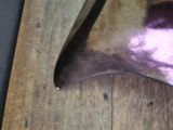 a knife on a cutting board with a purple handle