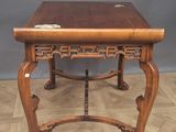 an old wooden table with a wooden top on a wooden floor