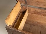 a wooden chest with a closed lid on a white surface