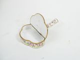 a small white box with a pink flower design on it
