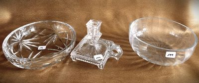 a glass bowl and a glass candle holder on a brown cloth