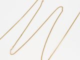 a gold chain necklace with a heart pendant on it
